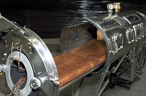 Photograph of a large metal iron lung ventilator