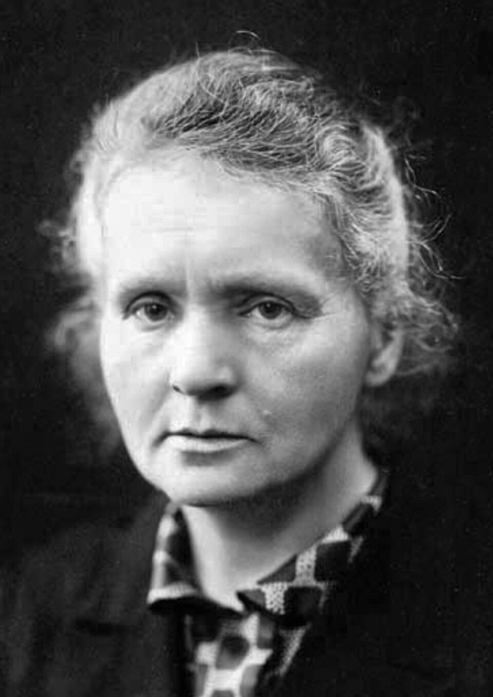 Black and white portrait photograph of Marie Curie